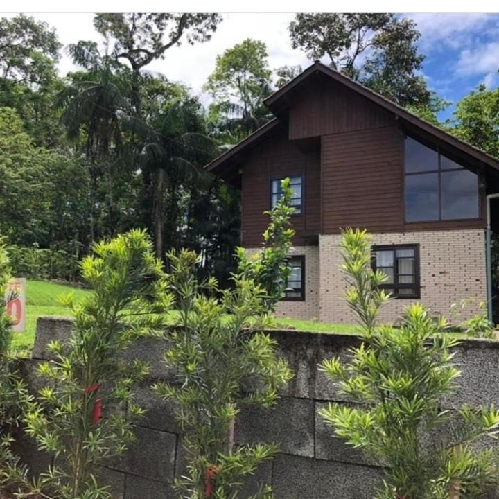 a house with trees in front of it at Casa de campo Rosa dos ventos in Rodeio