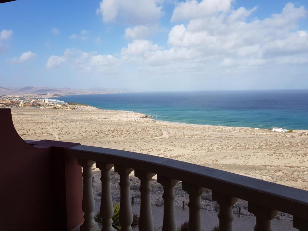 a balcony with a view of the beach at Sunshine in Costa Calma