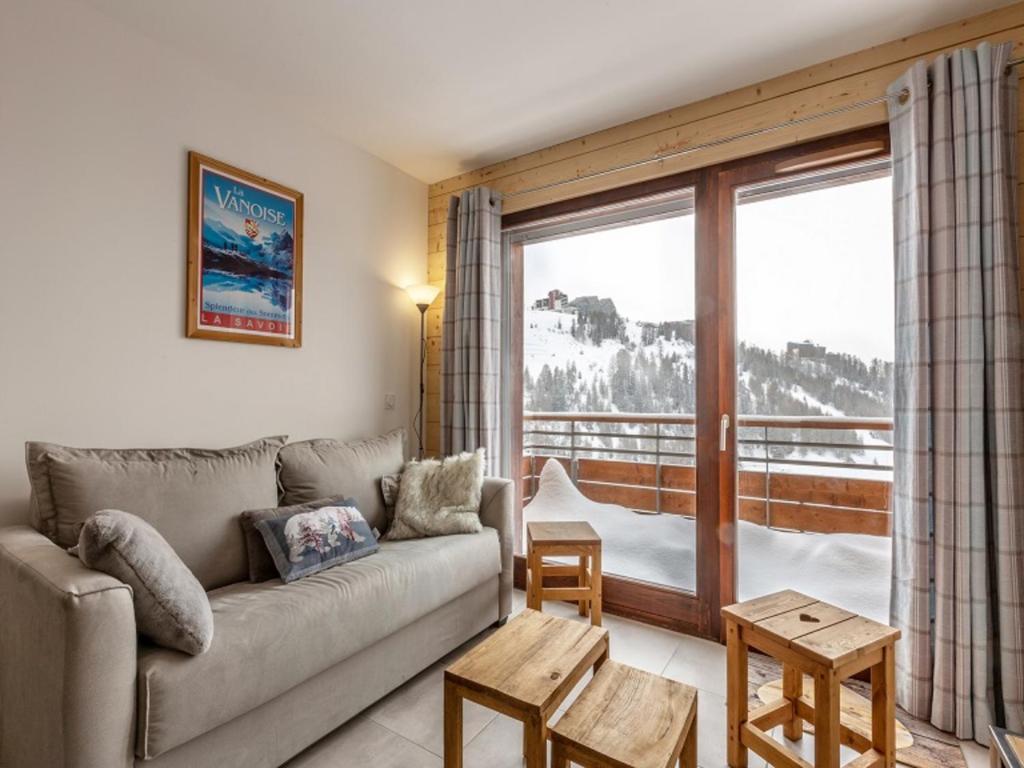 a living room with a couch and a large window at Appartement La Plagne, 3 pièces, 6 personnes - FR-1-351-93 in La Plagne