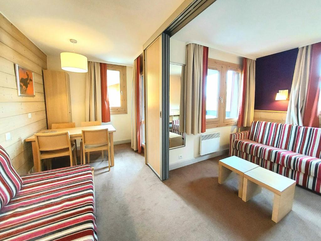 a living room with a couch and a table at Appartement La Plagne-Tarentaise, 1 pièce, 4 personnes - FR-1-351-146 in La Plagne Tarentaise