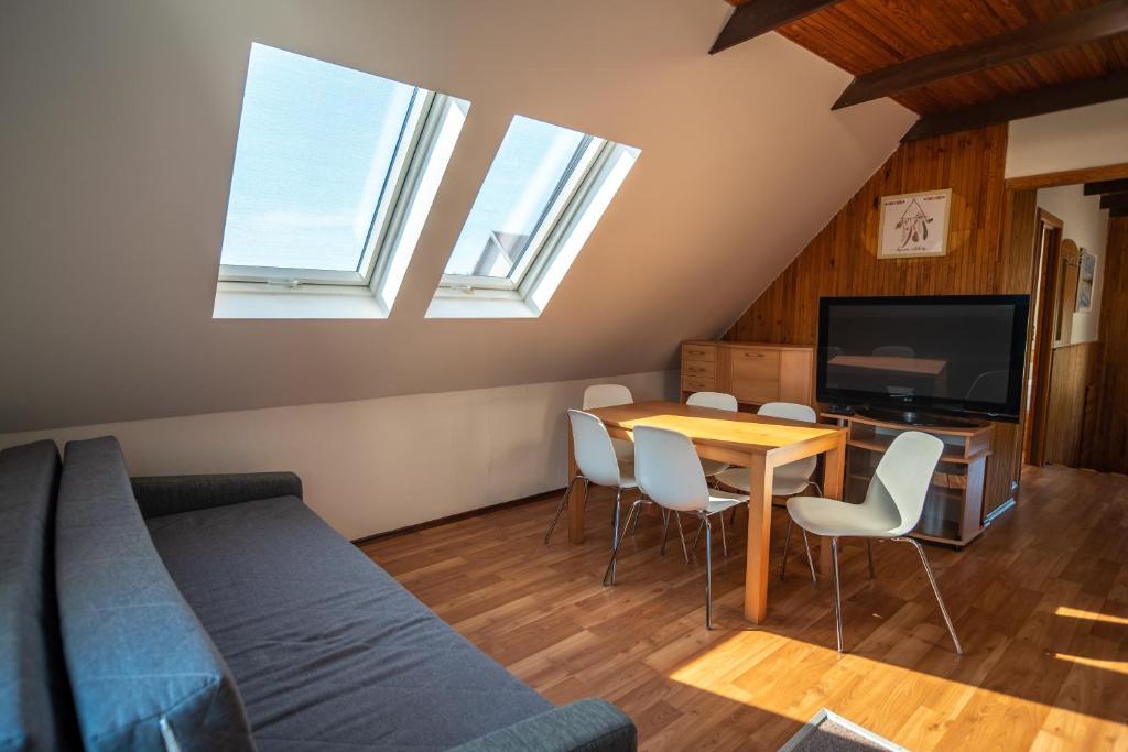 salon z kanapą, stołem i telewizorem w obiekcie Mikulov - Inn - hotel s vinným sklepem Venuše w mieście Mikulov