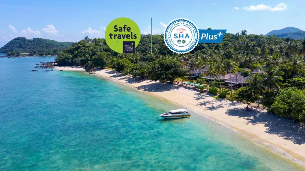 an aerial view of a beach with a boat in the water at Elixir Resort Koh Yao Yai - SHA Plus in Ko Yao Yai