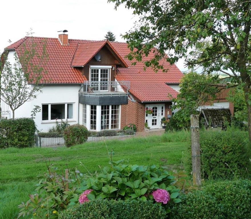 a white house with a red roof at Ferienwohnung Natur pur in Bad Pyrmont