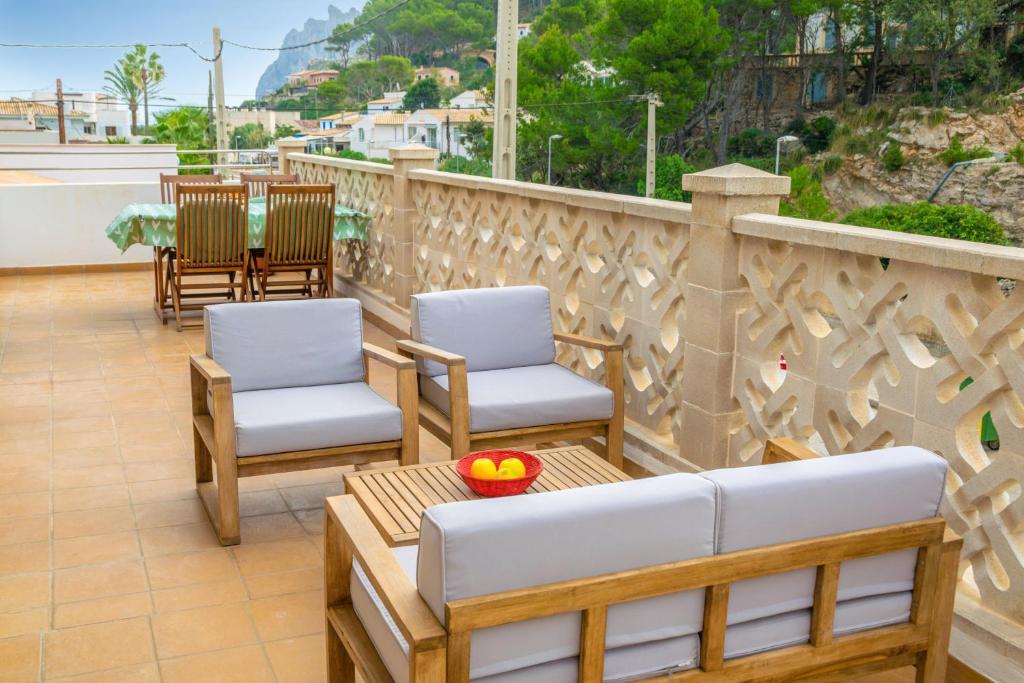 two chairs and a table on a balcony at Antoni Carbonell Sastre in Cala de Sant Vicenc