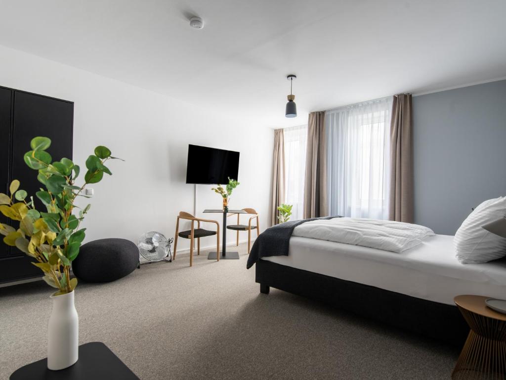 Postel nebo postele na pokoji v ubytování limehome Linz Friedrichstraße