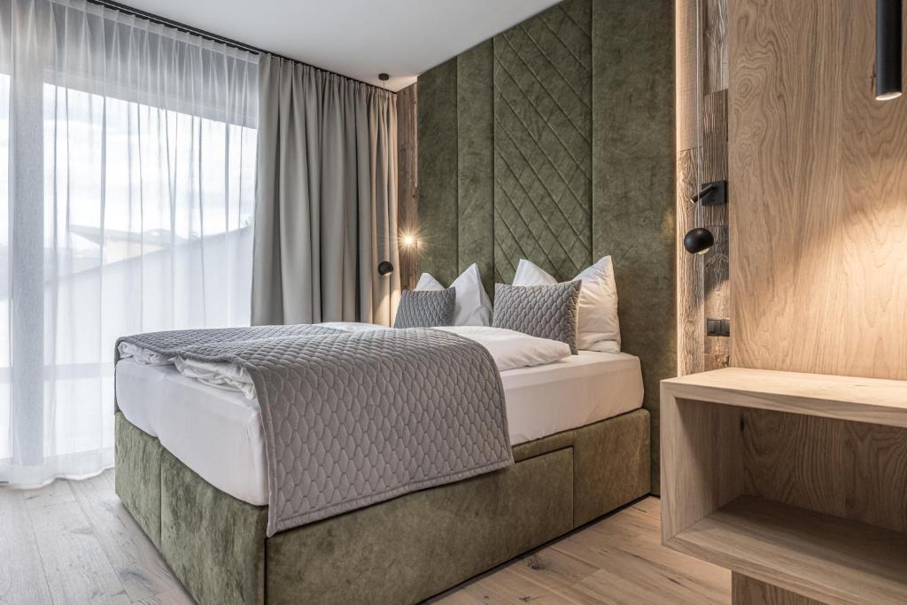 a bedroom with a bed and a large window at Perfect Lodgings Panorama in Hart im Zillertal