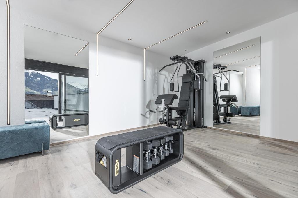 a living room with a gym with mirrors at Perfect Lodgings Panorama in Hart im Zillertal