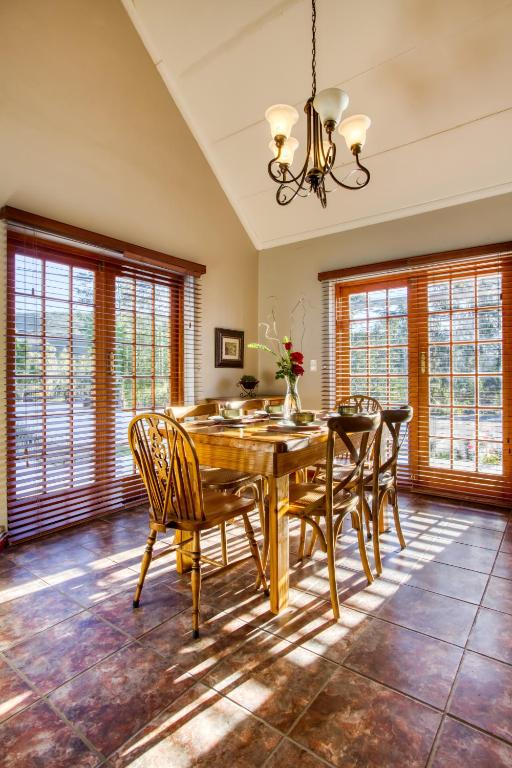 a dining room with a wooden table and chairs at Lady Grey Walk Mcgregor Cottage in McGregor