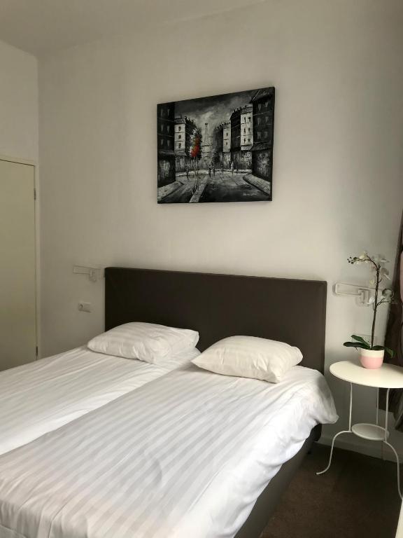 Postel nebo postele na pokoji v ubytování New City Hotel Scheveningen