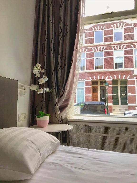 Postel nebo postele na pokoji v ubytování New City Hotel Scheveningen