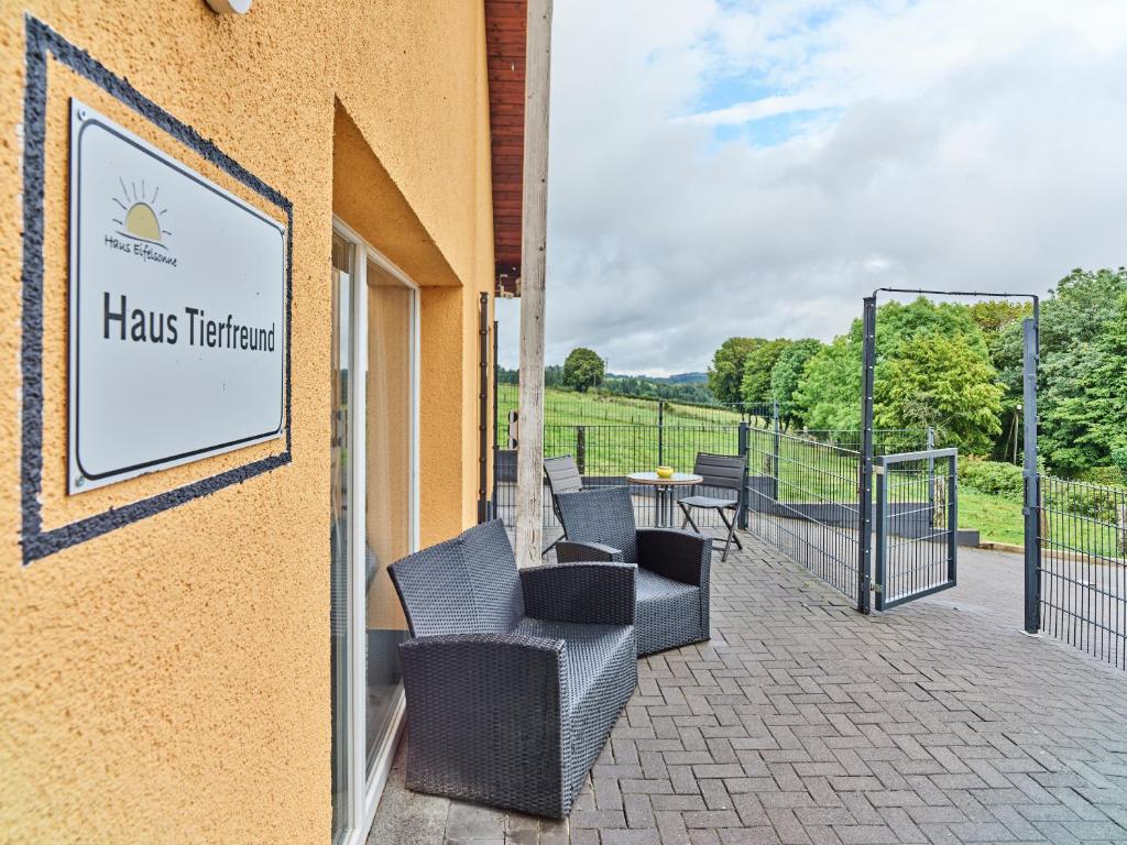 a sign on the side of a building with chairs at Haus Tierfreund in Hellenthal