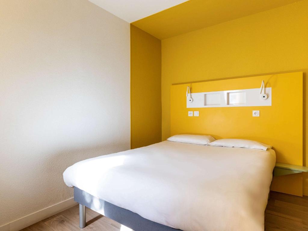 Postel nebo postele na pokoji v ubytování Ibis Budget Lyon Est Saint Quentin Fallavier