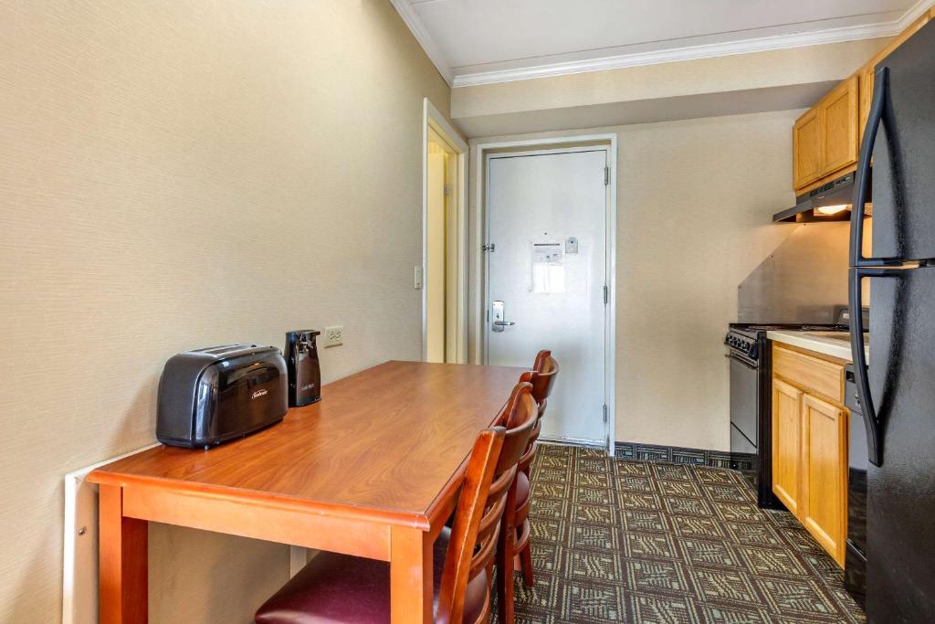 a kitchen with a table with chairs and a refrigerator at Quality Inn Boardwalk in Ocean City