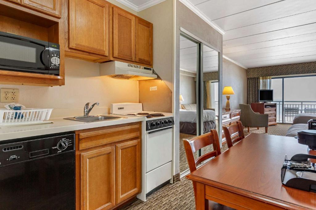 a kitchen with a sink and a stove top oven at Quality Inn Boardwalk in Ocean City