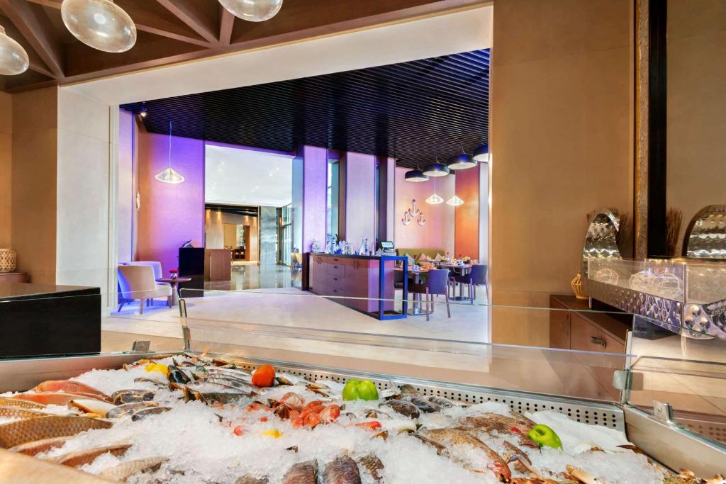 a buffet in a hotel with a large at Wyndham Garden Ajman Corniche in Ajman 