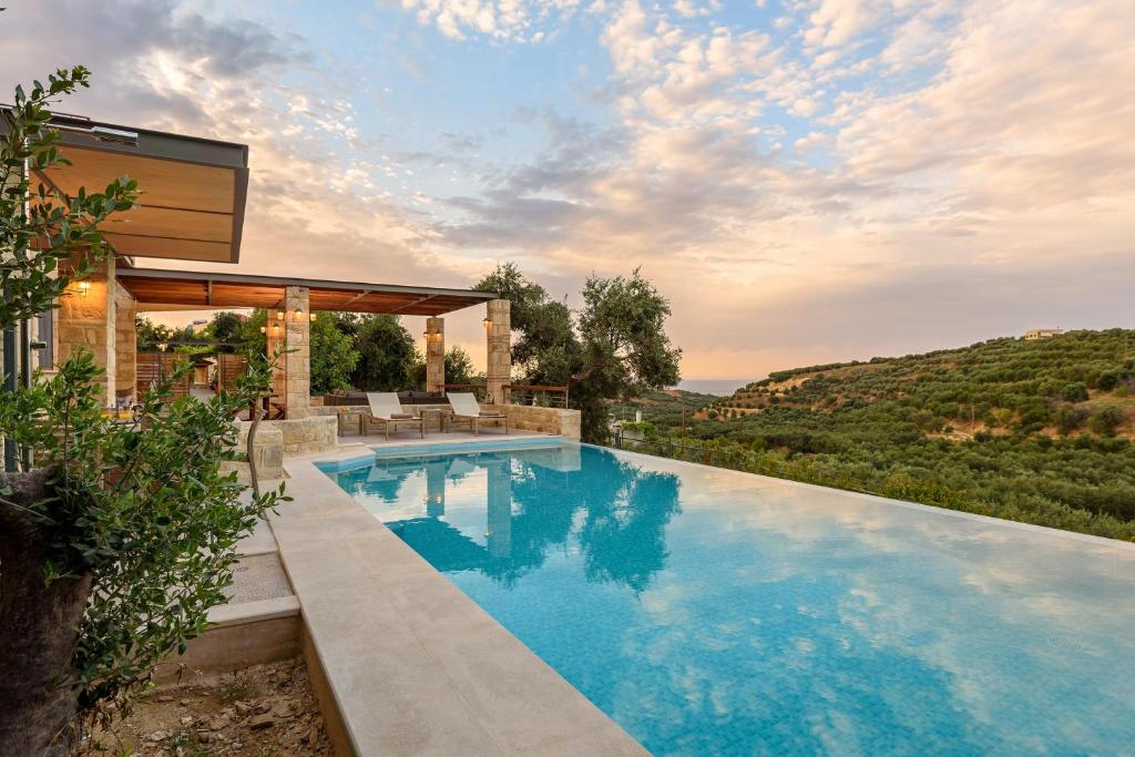 a swimming pool in the backyard of a house at Margarita's Villas in Chania Town