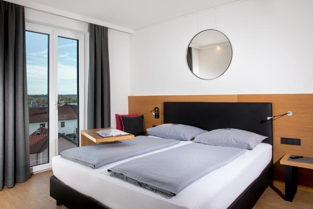 Postel nebo postele na pokoji v ubytování Motel Inn Simbach
