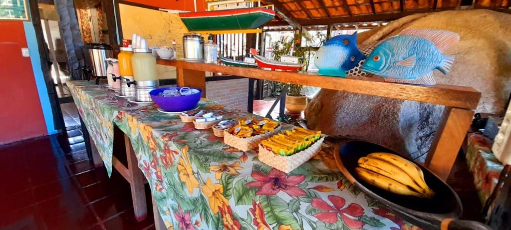 a table with a table cloth with food on it at Pousada Por do Sol in Ilhabela