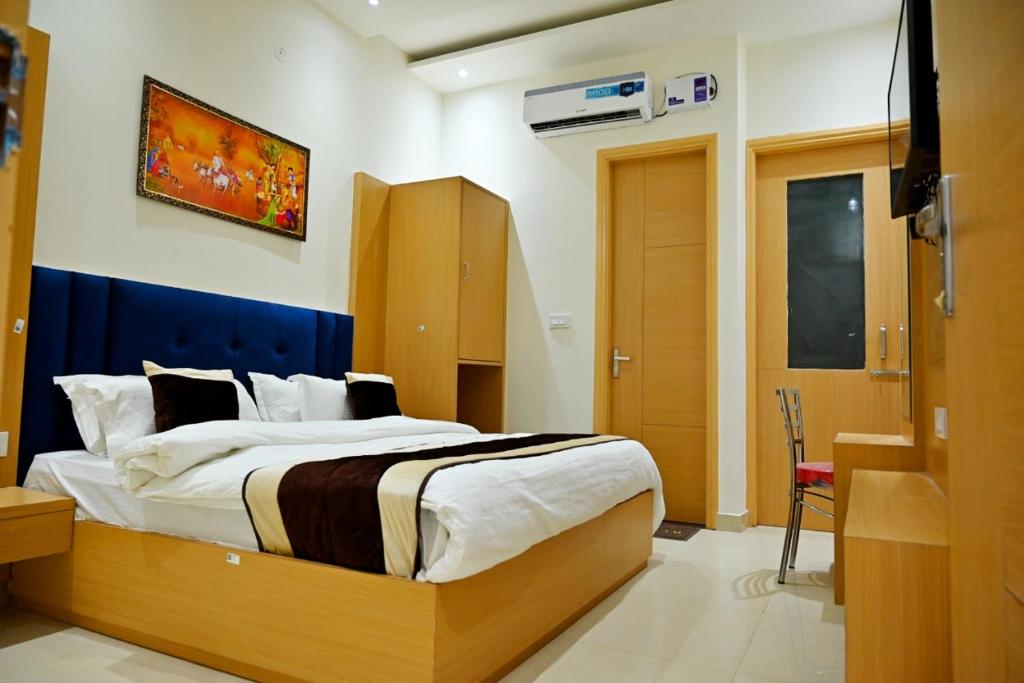 a bedroom with a large bed in a room at KOZZY B&B in Amritsar