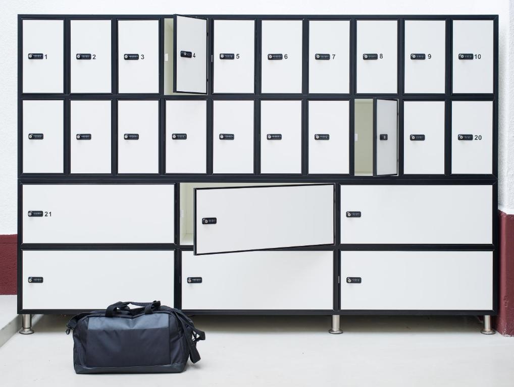 a row of lockers with a bag in front of them at RES City Residence Hotel Budapest in Budapest