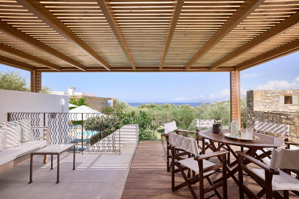 a patio with a table and chairs and a view at Thalassa Villas in Agios Nikolaos