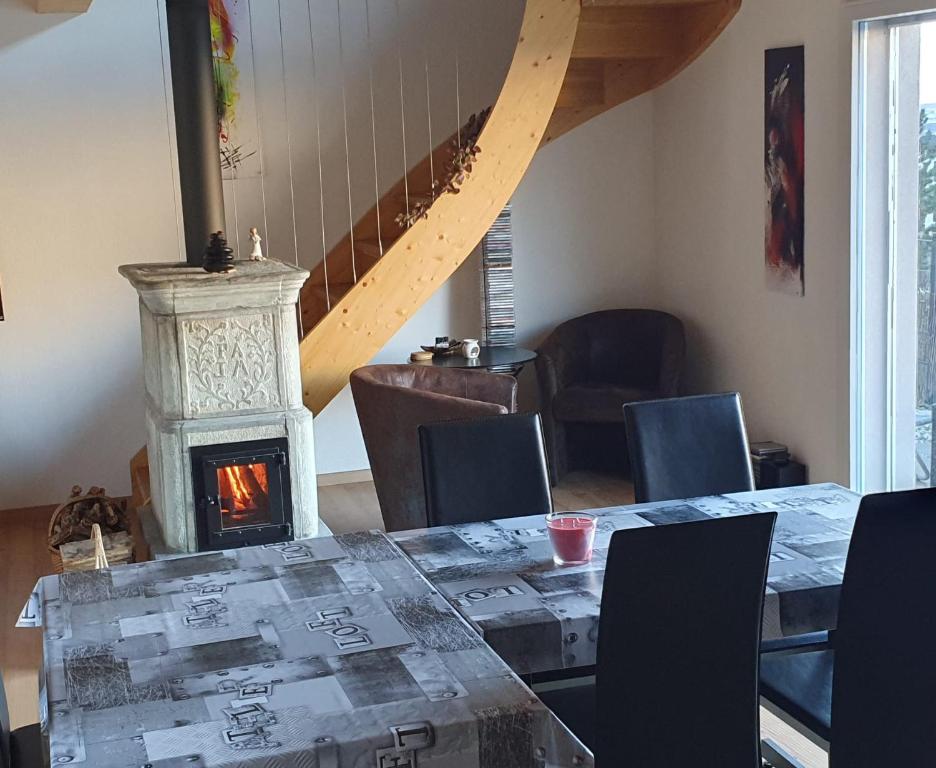 a dining room with a table and a fireplace at Charmant loft situé à 10 minutes de Vercorin in Rechy