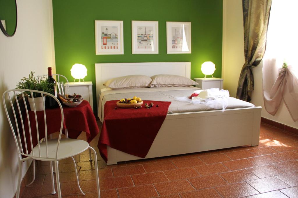 a bedroom with a bed and a table and chairs at Retrò Rooms in Cefalù