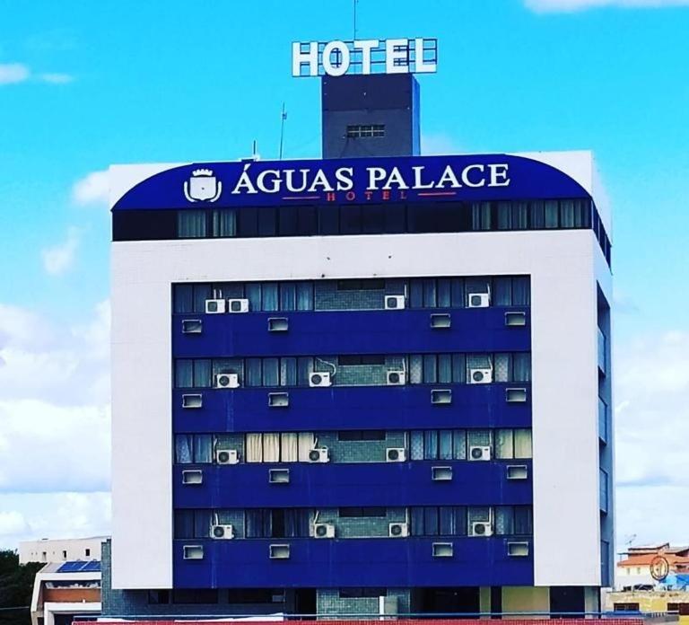 a hotel with a sign on top of a building at Águas Palace Hotel in Petrolina