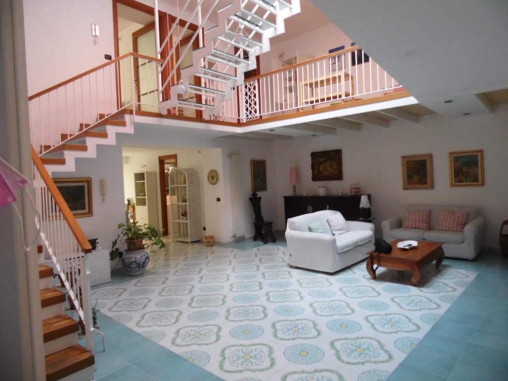 a living room with a staircase and a couch at A Casa di Monica in Pozzuoli