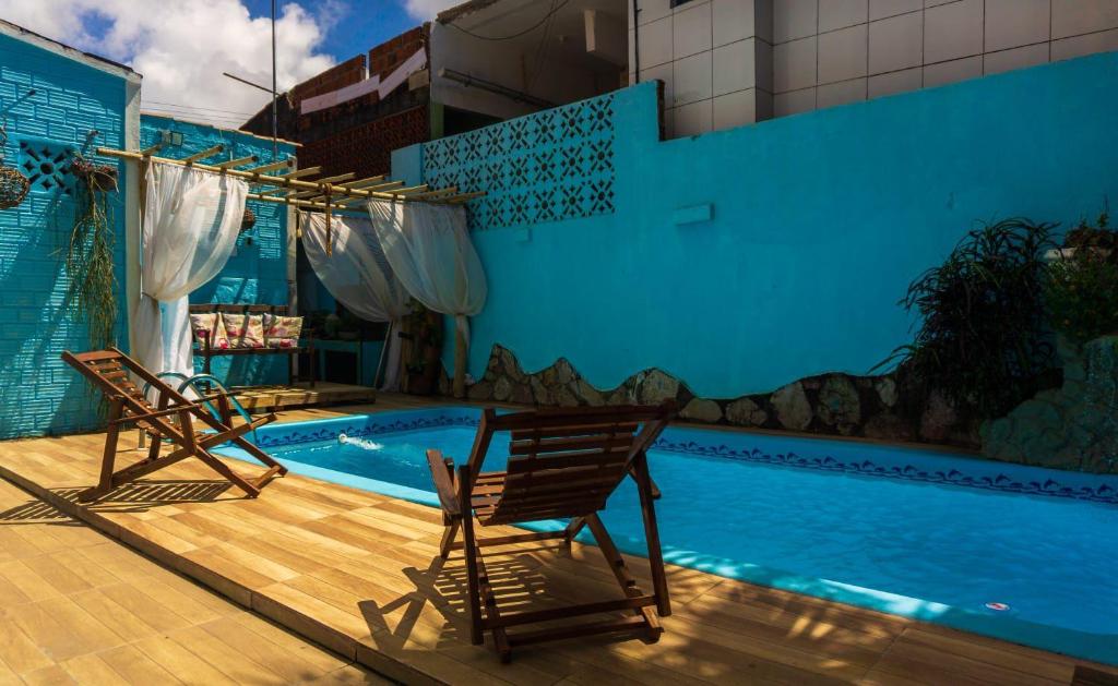 two chairs sitting next to a swimming pool at Pousada Sonho Meu in Pipa