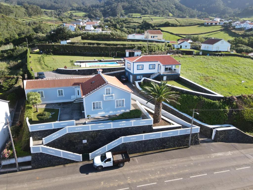 a white truck parked in front of a house at Quinta Rico in Quatro Ribeiras