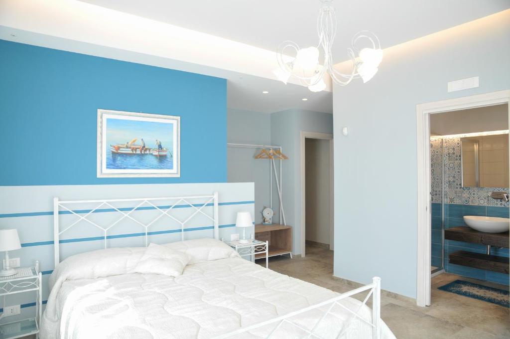 Łóżko lub łóżka w pokoju w obiekcie La Casa dell'Alloro