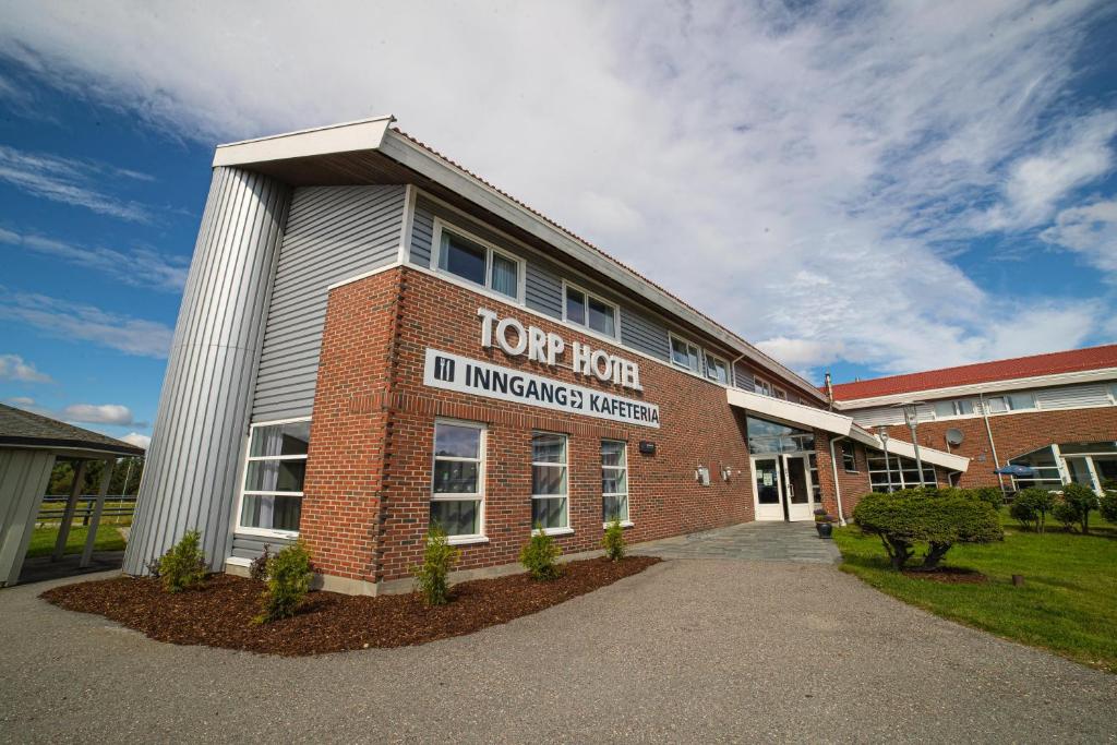 a building with a sign on the front of it at Torp Hotel in Sandefjord