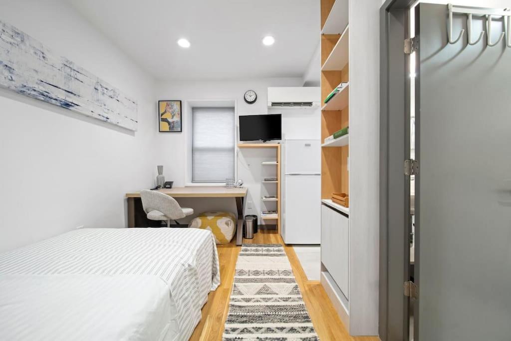 a small bedroom with a bed and a desk at Corporate Style Studio Near State House in Boston