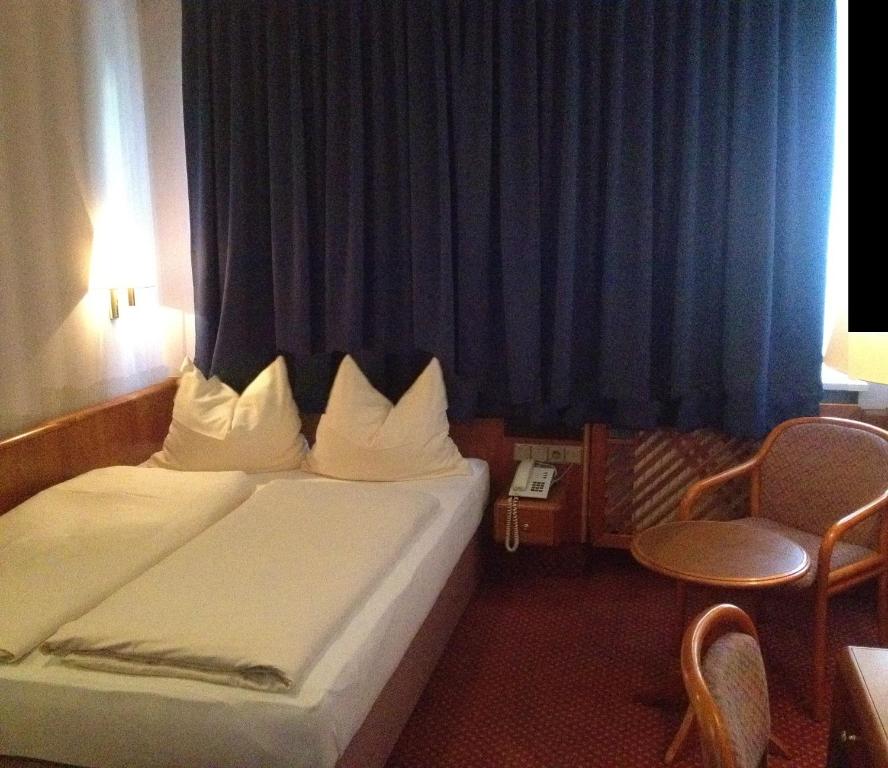 Postel nebo postele na pokoji v ubytování Hotel Carmen