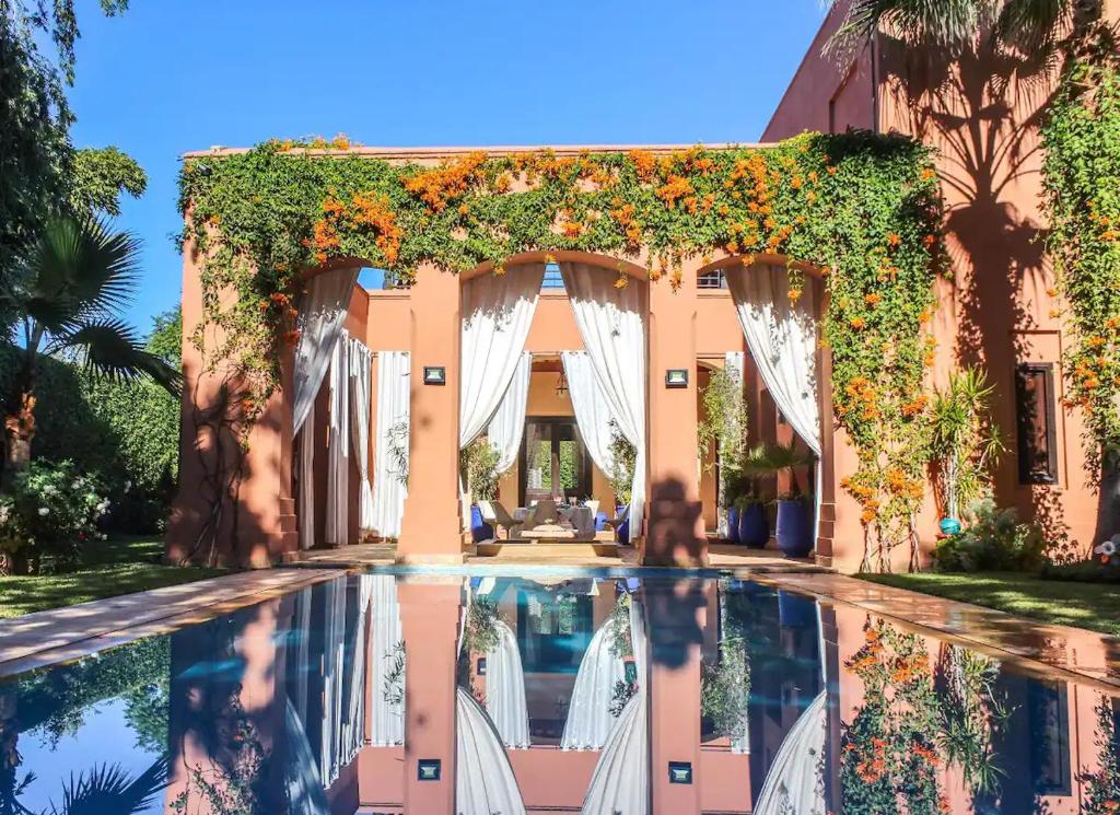 an entrance to a villa with a swimming pool at Magnificent Villa "Golf Amelkis" in Marrakesh