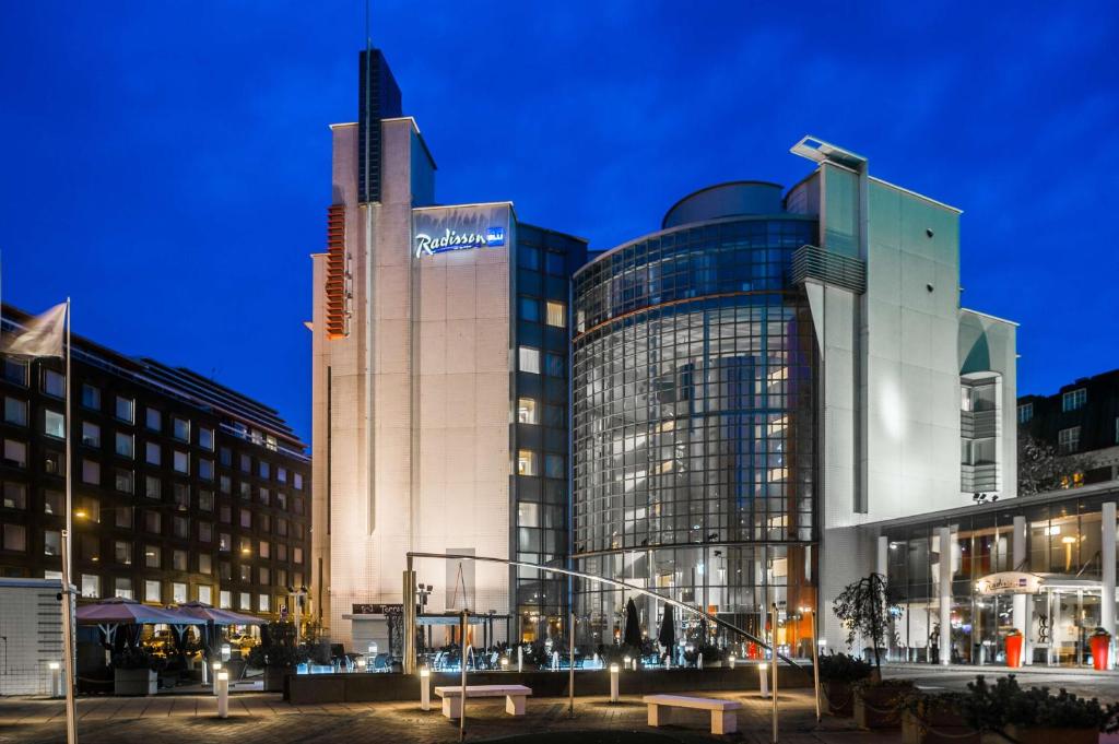 a large building with a sign on it at night at Radisson Blu Royal Hotel, Helsinki in Helsinki