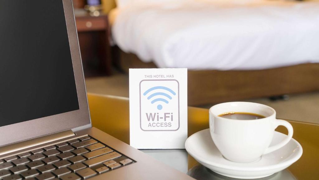 a laptop computer and a cup of coffee on a table at Castaways Resort and Suites in Freeport