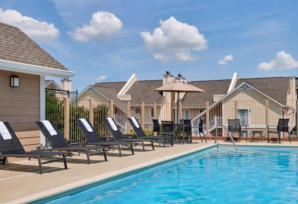 a pool with chaise lounge chairs and a swimming pool at AVIA on Mays Landing in Somers Point