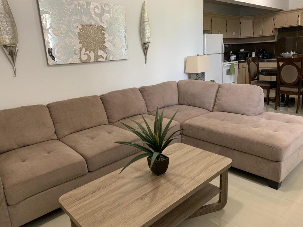 a living room with a couch and a coffee table at Joe's Place- Private 3 Bedroom Apartment in Flora Pago Gardens