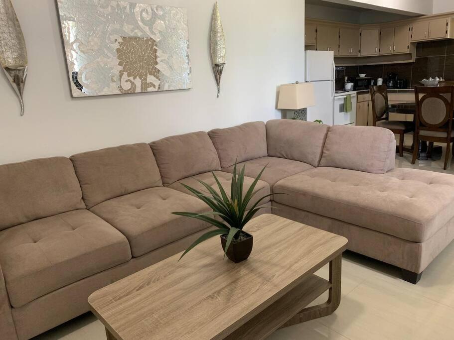 a living room with a couch and a coffee table at Private/Central 3 Bedroom Home in Hagatna