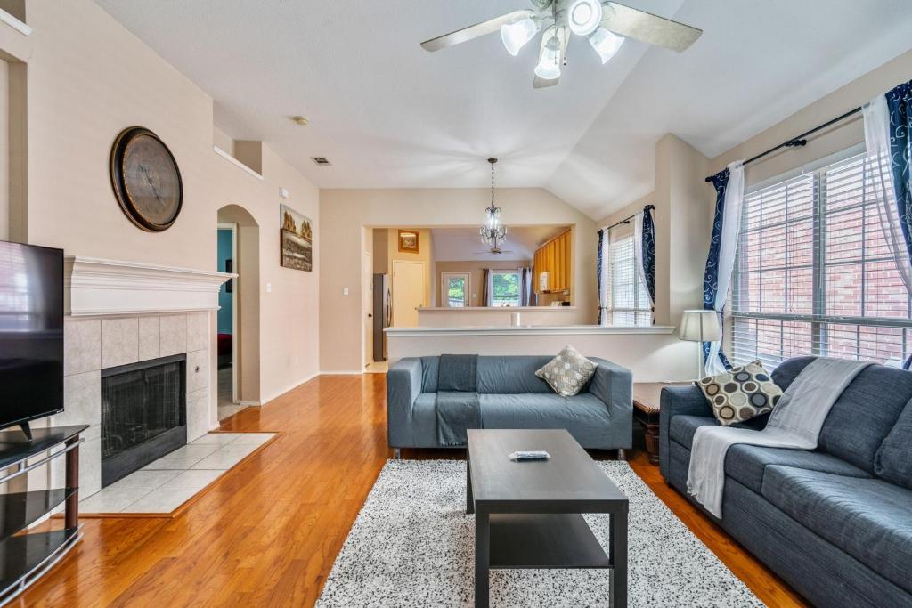 a living room with a couch and a fireplace at Centrally located 3-Bedroom and 2-Bath The Colony Home with Great North Dallas Access home in The Colony