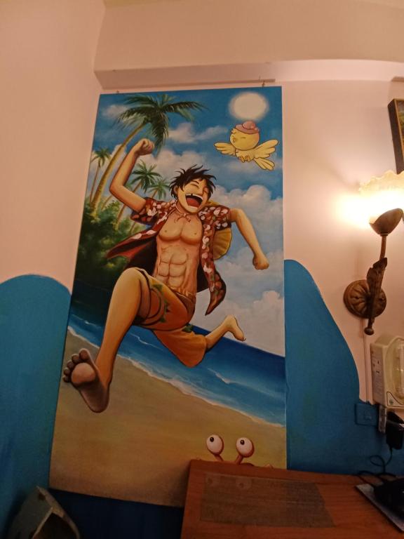 a mural of a man on a wall in a room at Hualien Seaside B&amp;B in Hualien City