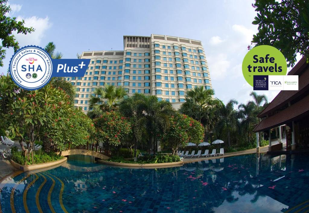 a large swimming pool in front of a large building at Rama Gardens Hotel Bangkok - SHA Plus Certified in Bangkok