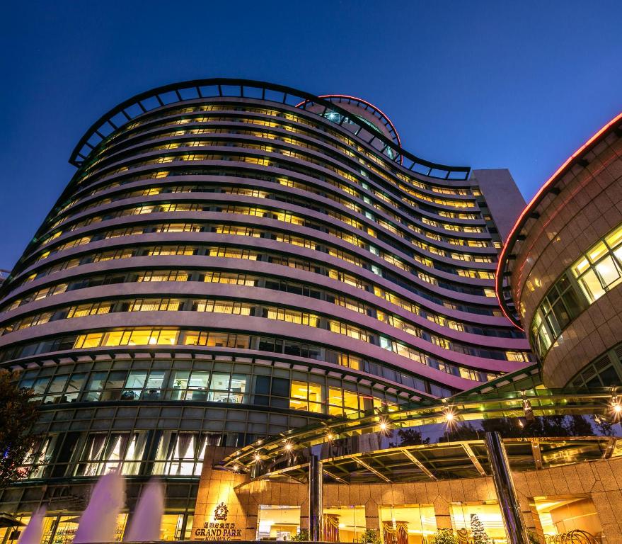 a tall building with many windows at night at Grand Park Kunming in Kunming