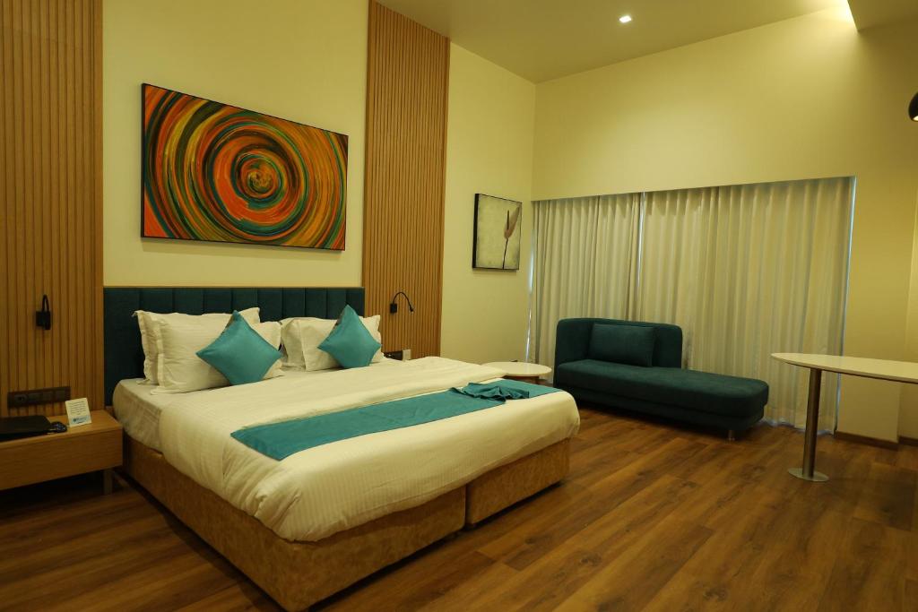 Postel nebo postele na pokoji v ubytování Hotel Blueivy Anand