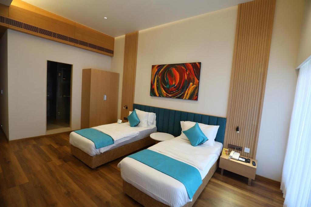 Postel nebo postele na pokoji v ubytování Hotel Blueivy Anand