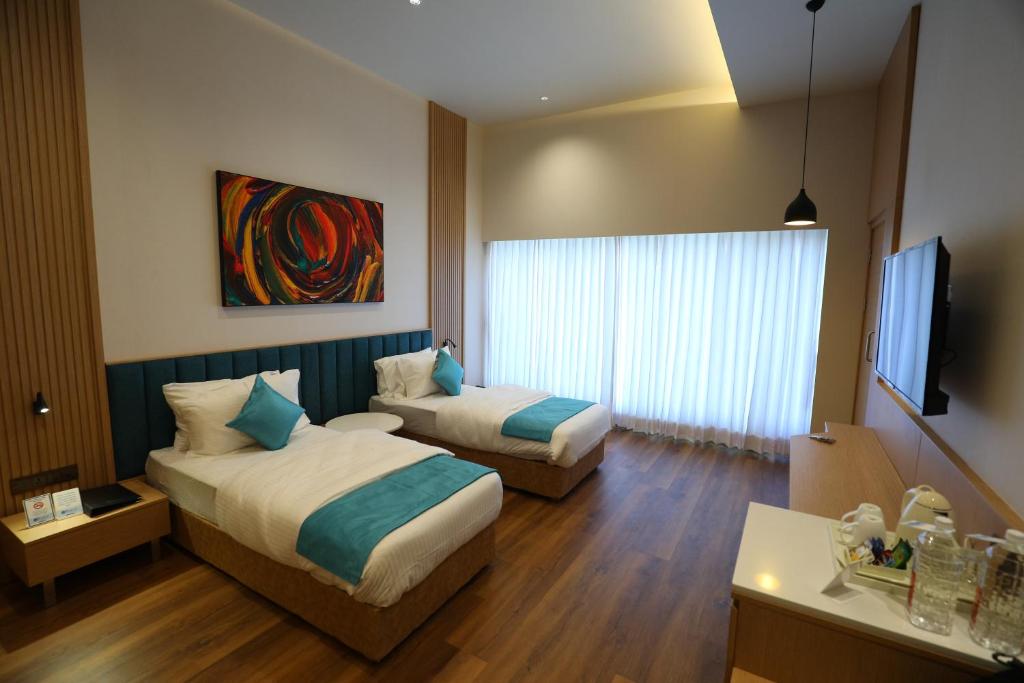 Postel nebo postele na pokoji v ubytování Hotel Blueivy Anand