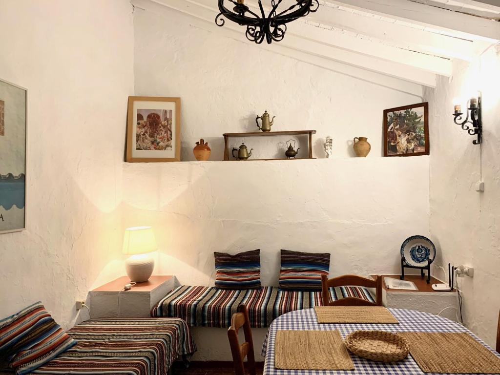 a living room with two beds and a couch at La Casilla- La Almona Chica in El Chorro
