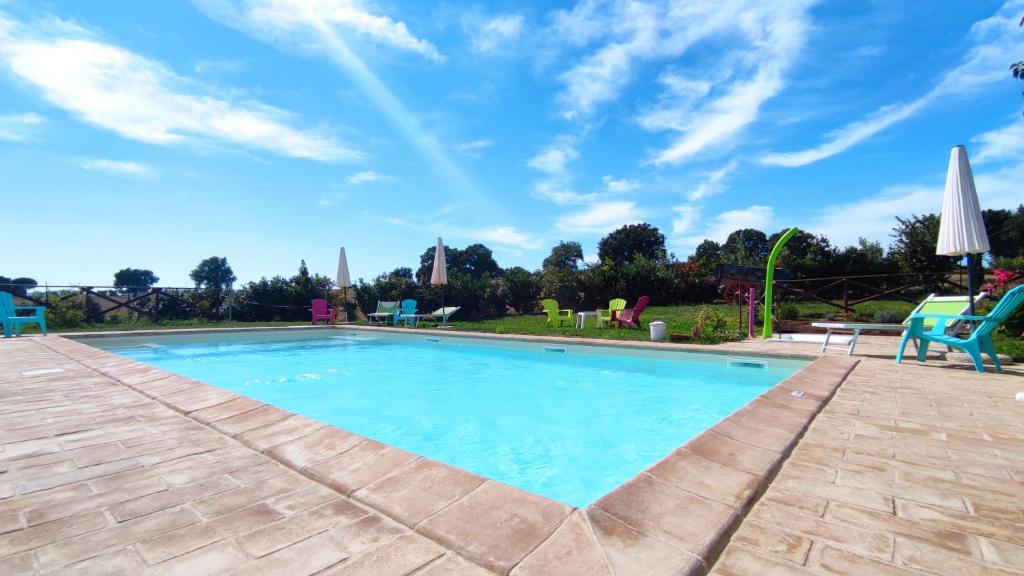 a large swimming pool with a blue sky at Fattoria Il Bruco in Pila